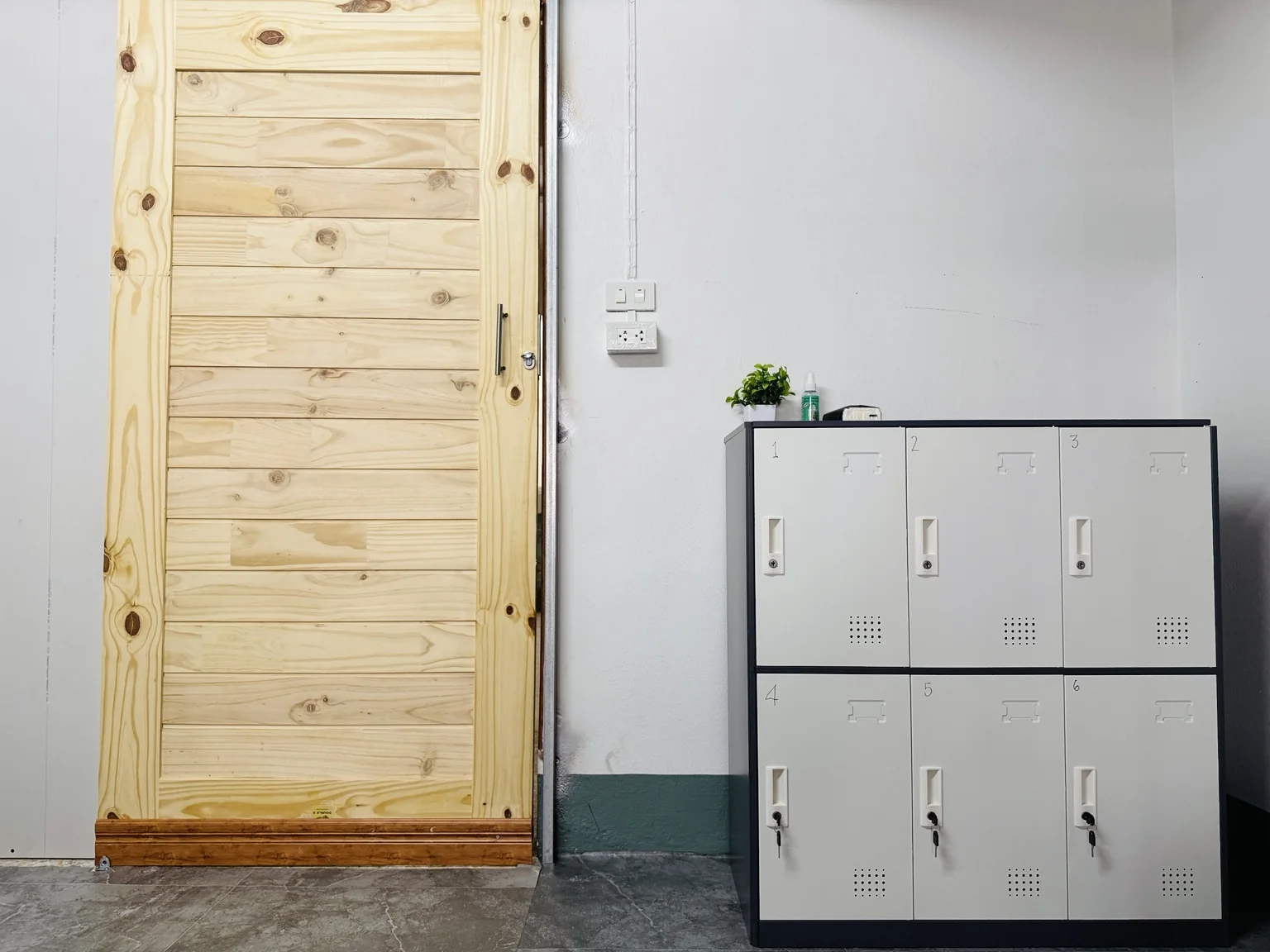 Guest lockers beside wooden door